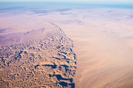 The mountains meet the plain in Egyptian Sahara.の写真素材