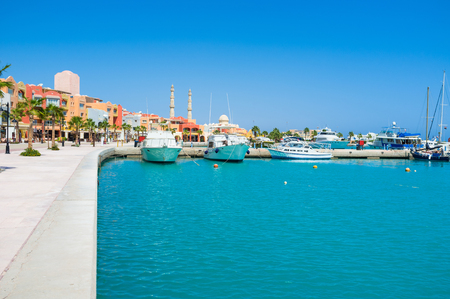 The bright blue waters of the Red sea surrounded by the modern colorful buildings of Marina, Hurghada, Egypt.の写真素材