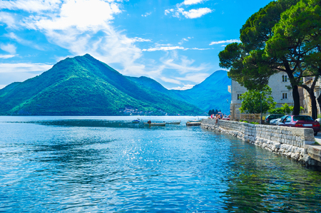 The nice views on the high mountains around the narrow bay, medieval architecture and bright blue sea makes Perast popular among tourists, Montenegro.の写真素材