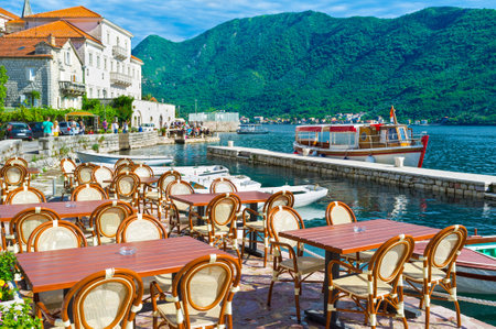 The Marina of Perast is the best place for outdoor cafe, visitors enjoy the medieval architecture, high mountains, fresh sea air and the scenic boats, Montenegro.のeditorial素材