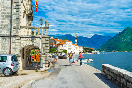 PERAST, MONTENEGRO - JULY 13, 2014: The best choice for daily walks is the promenade with its cafes, bars, souvenir shops and art galleries, on July 13 in Perast.のeditorial素材