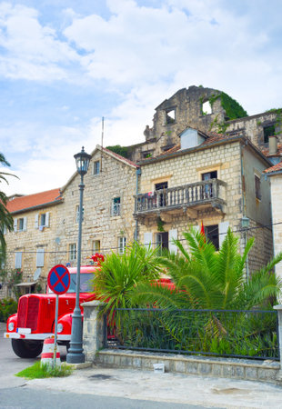 The fire station of Perast with the red fire truck, parked in front of it, Perast, Montenegro.のeditorial素材