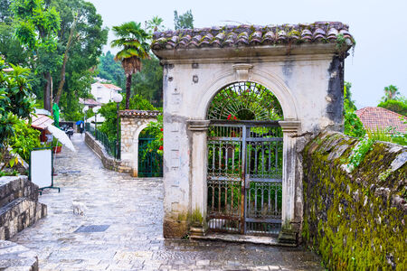 The old gates to the scenic lush gardens, surrounding the villas of Herceg Novi, Montenegro.の写真素材