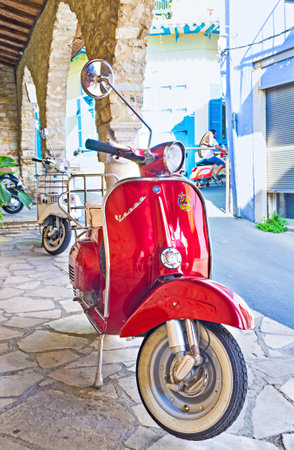 LEFKARA, CYPRUS - AUGUST 2, 2014: The red scooter is parked on the restaurant terrace, on August 2 in Lefkara.のeditorial素材