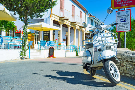 LEFKARA, CYPRUS - AUGUST 2, 2014: The white scooter parked next to the restaurant, on August 2 in Lefkara.のeditorial素材