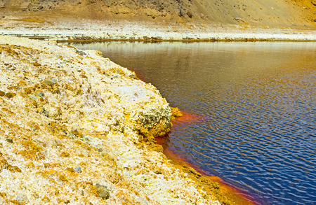 The yellow bank of the mine lake with the sulfur crystals, Sia, Cyprus.の写真素材