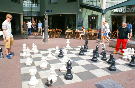 AMSTERDAM - JULY 1, 2010: People playing chess on big chess board in the backyard of Max Euwe Centrum,  on July 1 in Amsterdamのeditorial素材