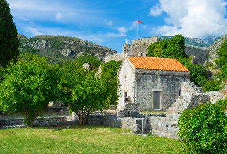 The small stone church surrounded by scenic green garden, Stari Bar, Montenegro.のeditorial素材