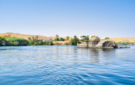The tiny rocky islets in Nile surrounds the western river bank next to the Elephantine Island,...