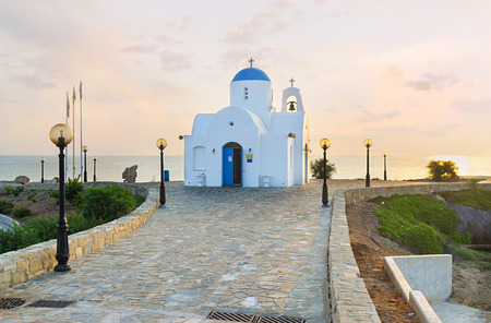 The coastal church of Agios Nikolaos located next to the Golden Coast harbor on the scenic promenade, Protaras, Cyprus.の写真素材