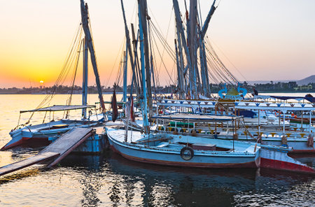 The traditional egyptian feluccas looks romantic during the sunset, Luxor, Egypt.