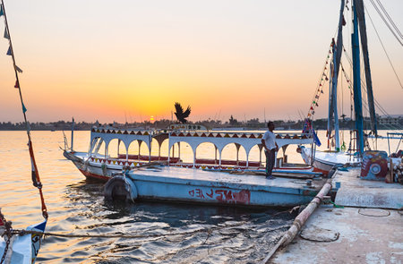 LUXOR, EGYPT - OCTOBER 7, 2014: The traditionally decorated and painted tourist motor boat in the shipyard, on October 7 in Luxor.のeditorial素材