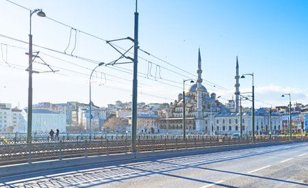 ISTANBUL, TURKEY - JANUARY 13, 2015: The tram line on Galata Bridge with the New Mosque on the background, on January 13 in Istanbul.のeditorial素材