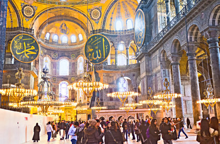 ISTANBUL, TURKEY - JANUARY 13, 2015: Tourists enjoy interior of Hagia Sophia with the calligraphic medallions and pendant chandeliers, on January 13 in Istanbul.のeditorial素材