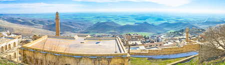 The green Mesopotamian plain is hidden behind the medieval roofs of Mardin, Turkey.のeditorial素材