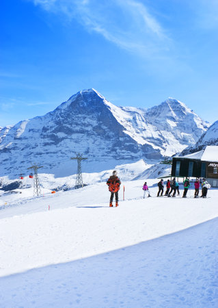 GRINDELWALD, SWITZERLAND - MARCH 22, 2011: The skiers next to the top station of GrindelwaldâMannlichen gondola cableway, on March 22 in Grindelwald.のeditorial素材