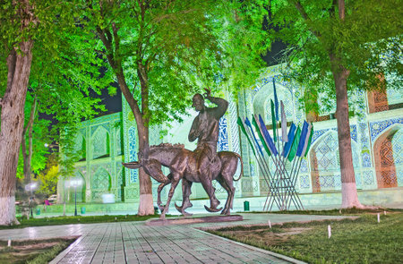 BUKHARA, UZBEKISTAN - APRIL 28, 2015: The monument to Nasreddin Hodja with the Nadir Divan-Beghi madrasah on the background, on April 28 in Bukhara.のeditorial素材