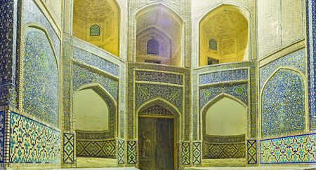 The central entrance to the Mir-i Arab Madrassa decorated with traditional tiled traceries, Bukhara, Uzbekistan.の写真素材