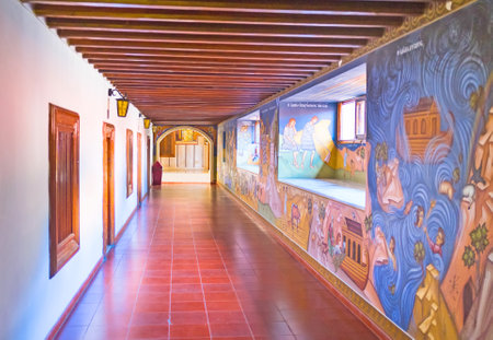 TROODOS, CYPRUS - AUGUST 2, 2014: The long hall of the Kykkos Monastery with the wooden ceiling and walls covered with paintings, on August 2 in Troodos.のeditorial素材