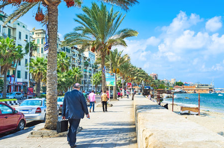 ALEXANDRIA, EGYPT - OCTOBER 11, 2014: The comfortable promenade with the shady palms, numerous cafes and shops in the city centre, on October 11 in Alexandria.のeditorial素材