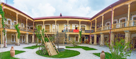 SAMARKAND, UZBEKISTAN - APRIL 30, 2015: The wooden Caravan Saray, that also serves as the art center, with the traditional country yard, on April 30 in Samarkand.のeditorial素材