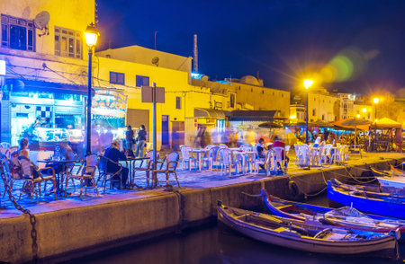 BIZERTE, TUNISIA - SEPTEMBER 4, 2015: Outdoor city cafes in port are very popular among tourists and locals, on September 4 in Bizerte.のeditorial素材