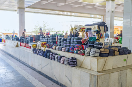 SAMARKAND, UZBEKISTAN - APRIL 30 , 2015: The old merchant in stall of traditional Uzbek skullcaps in Siab Bazaar, on April 30 in Samarkand.のeditorial素材
