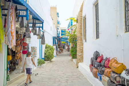 HAMMAMET, TUNISIA - SEPTEMBER 6, 2015: Even the quiet narrow streets of Medina boasts the tourist stalls, on September 6 in Hammamet.のeditorial素材