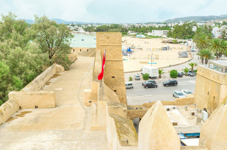 HAMMAMET, TUNISIA - SEPTEMBER 6, 2015: The fortress wall overlooks the coastline of Hammamet with...