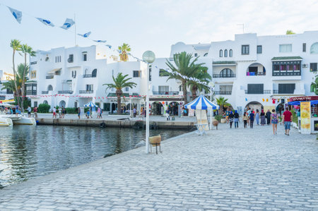 AL KANTAOUI, TUNISIA - AUGUST 29, 2015: The cozy promenade is the best place for evening walks with many cafes and souvenir stalls, on August 29 in Al Kantaoui.のeditorial素材