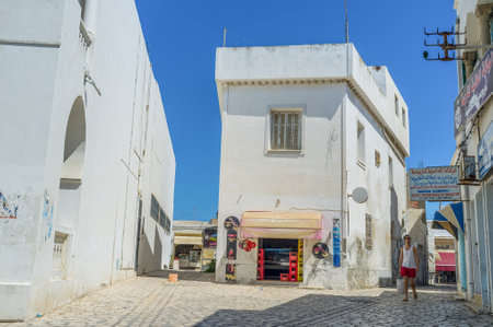MAHDIA, TUNISIA - AUGUST 29, 2015: The narrow street of Medina consists of the small white houses,...