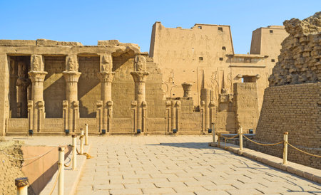 The ruins of the Mammisi (the birth house) with the ancient temple of Horus on the background,...