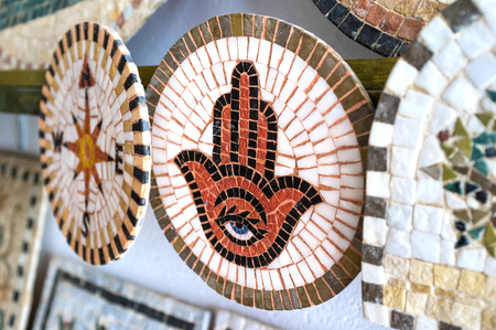 The stone mosaic with the popular protecting amulet known as Hamsa or Hand of Fatima, Sousse, Tunisia.の写真素材