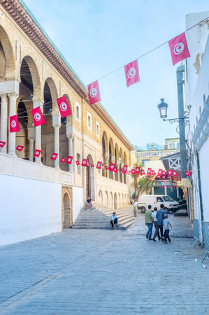 TUNIS, TUNISIA - AUGUST 30, 2015: The square in front of Zaytouna Mosque decorated with many small national flags, on August 30 in Tunis.のeditorial素材