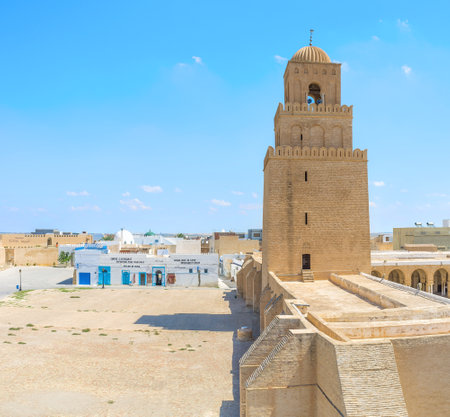 KAIROUAN, TUNISIA - AUGUST 30, 2015: The brick minaret of Great Mosque of Kairouan (Mosque of Uqba) surrounded by large trading area, on August 30 in Kairouan.のeditorial素材