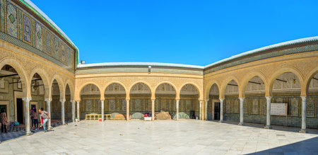 KAIROUAN, TUNISIA - AUGUST 30, 2015: The courtyard in front of the prayer hall of Barber's mosque, decorated with colorful patterns of glazed tiles, on August 30 in Kairouan.のeditorial素材