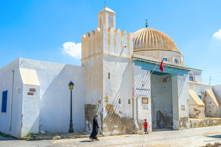 KAIROUAN, TUNISIA - AUGUST 30, 2015: The beautiful mosque with the large ribbing dome, that is a...