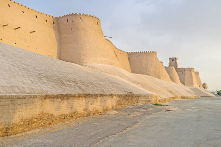 The sunset rays fall on the ramparts of the medieval fortress of Khiva, Uzbekistan.のeditorial素材