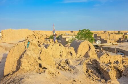 The medieval rampart and historic tombs on it were covered with clay, that was washed away by rain water, Khiva, Uzbekistan.の写真素材