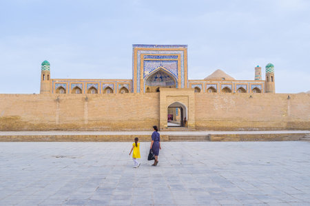 The Muhammad Rahim-khan Madrasah behind the high brick wall, Khiva, Uzbekistan.のeditorial素材