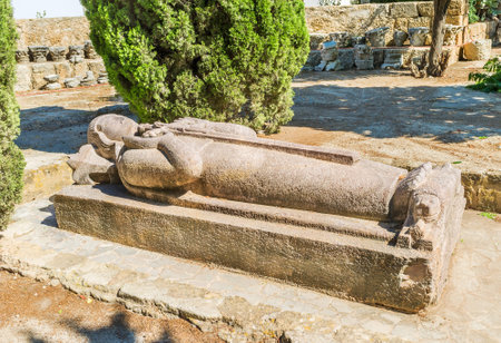 CARTHAGE, TUNISIA - SEPTEMBER 2, 2015: The royal tomb decorated with the statue of the king holding the sword, on September 2 in Carthage.のeditorial素材