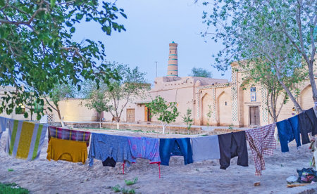 The drying clothes in the old town of Khiva with the medieval workshop and market quarter on the background, Uzbekistan.のeditorial素材