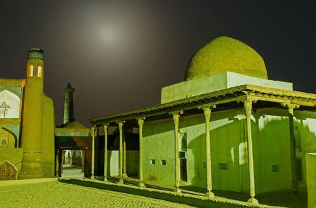 The medieval White Mosque and East Gates to Itchan Kala, illuminated by the moonlight, Khiva, Uzbekistan.の写真素材