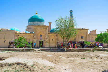KHIVA, UZBEKISTAN - MAY 4, 2015: The market street with the colorful dome of Pahlavon Mahmud Mausoleum and Islam Khoja Minaret on the background, on May 4 in Khiva.のeditorial素材