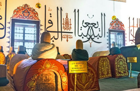 KONYA, TURKEY - JANUARY 20, 2015: The medieval sarcophagi in Mevlana Museum decorated with embroidered islamic patterns and turbans, on January 20 in Konya.のeditorial素材