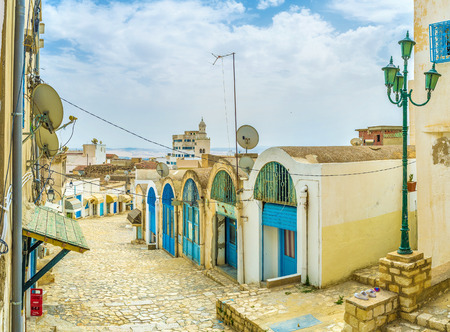 The descent in old town with the numerous workshops on each side of the street in the working neighborhood in El Kef.の写真素材