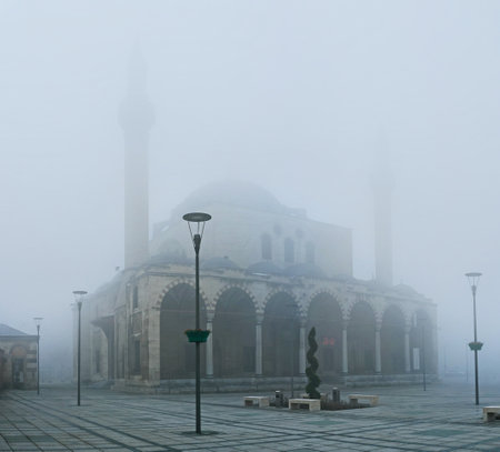 The hard mist hides the beauty of Selimiye Mosque, showing only its silhouette, Konya, Turkey.のeditorial素材