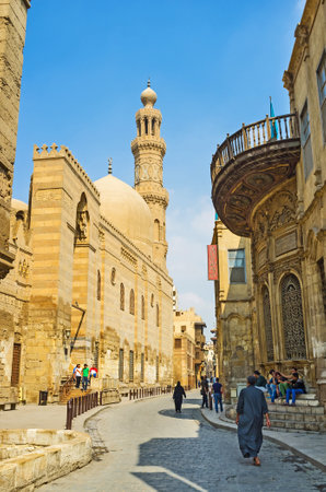 CAIRO, EGYPT - OCTOBER 10, 2014: The yellow  stone walls, minaret and dome of Madrasa and Khanqah of Sultan al-Zahir Barquq, on October 10 in Cairo.のeditorial素材