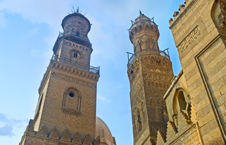 CAIRO, EGYPT - OCTOBER 10, 2014: Two neighboring minarets on Al-Muizz street compete in beauty and complexity of the carved decor, on October 10 in Cairo.のeditorial素材