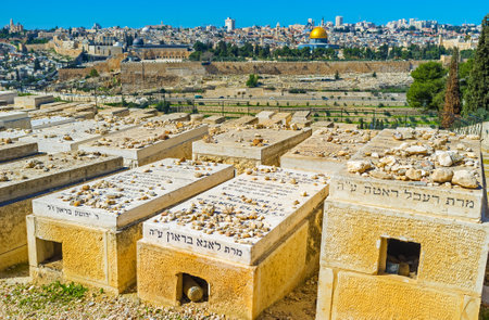 JERUSALEM, ISRAEL - FEBRUARY 16, 2016: The visitors of Jewish cemetery put the stones on the graves according to the ancient traditions, on February 16 in Jerusalem.のeditorial素材